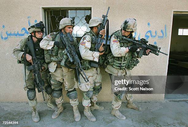 Army soldiers from the 1st Infantry Division's 2nd Battalion-2nd Regiment clear abandoned houses of insurgent fighters November 10, 2004 during...