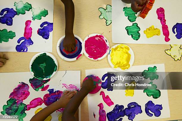 Young children work on a paint project at the 4 Kids Early Learning Center August 24, 2004 in Braddock, Pennsylvania. The center is funded mostly by...