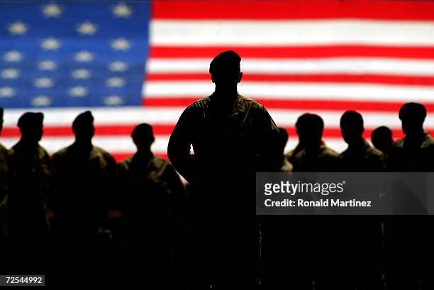 Colonel Don Campbell with members of the United States Army Fourth Infantry Division stand in front of the American flag prior to the home opener...