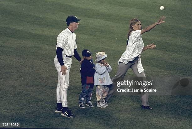 Pitcher David Cone of the New York Yankees stands with Charisse Strawberry and her children during the American League Championship Series Game 1...