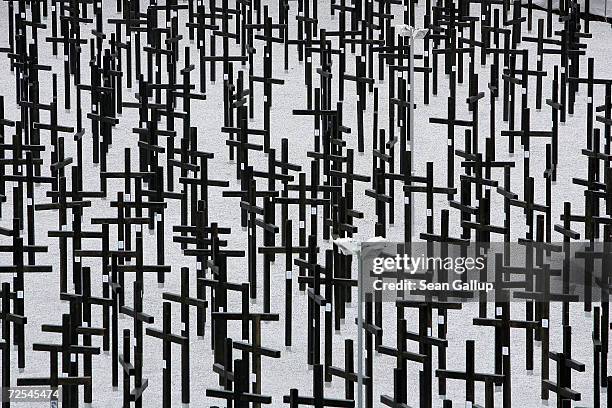 Crosses commemorate victims of the Berlin Wall during opening ceremonies of a new memorial by a rebuilt section of the Berlin Wall on the day of the...