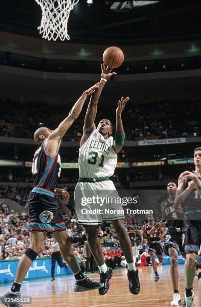 Forward Joe Johnson of the Boston Celtics shoots over forward Shane Battier of the Memphis Grizzlies during the NBA game at the FleetCenter in...