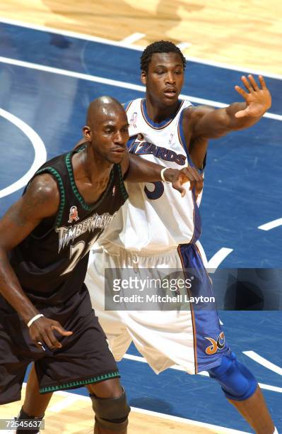 Forward Kevin Garnett of the of the Minnesota Timberwolves and forward Kwame Brown of the Washington Wizards attempt to catch the ball during the NBA...