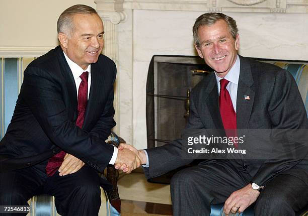 President George W. Bush shakes hands with Uzbek President Islam Karimov March 12, 2002 during their meeting at the Oval Office of the White House in...