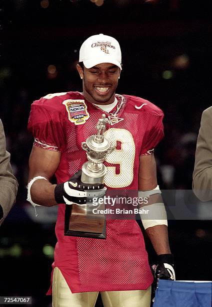Peter Warrick of the Florida State Seminoles smiles and holds his trophy for MVP of the game after the Nokita Sugar Bowl Game against the Virginia...