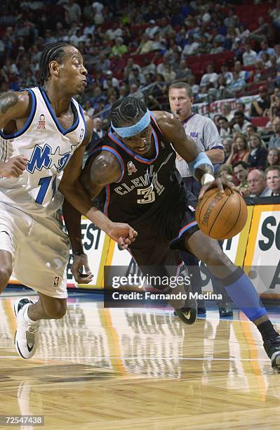 Guard Ricky Davis of the Cleveland Cavaliers drives past point guard Troy Hudson of the Orlando Magic during the NBA game at TD Waterhouse in...