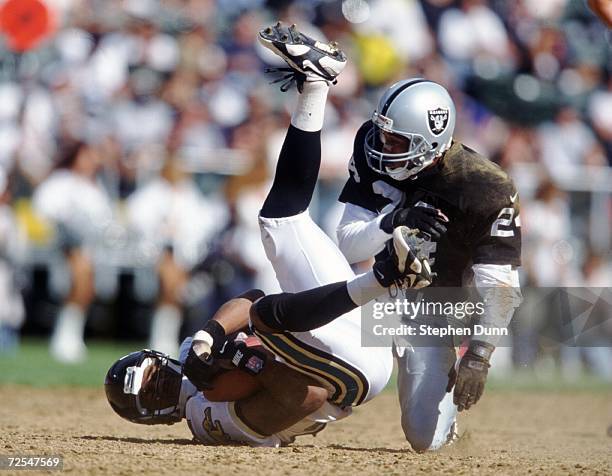 Defensive back Larry Brown of the Oakland Raiders puts a hit on receiver Jimmy Smith of the Jacksonville Jaguars during the Raiders 17-3 win at the...