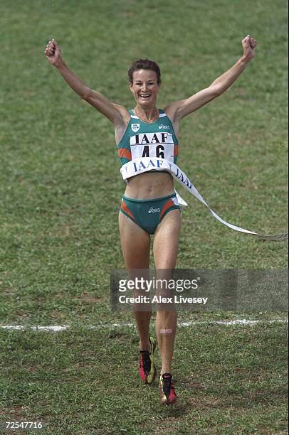 Sonia O'Sullivan of the Republic of Ireland raises her arms aloft as she crosses the line to win the gold medal in the Womens 4 kilometres event...