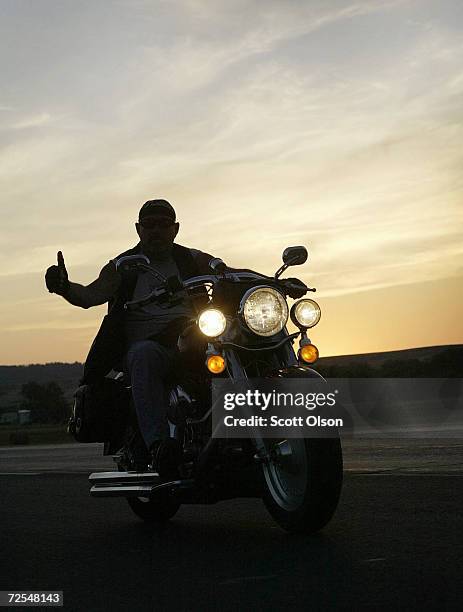 Biker rides his motorcycle during the annual Sturgis Motorcycle Rally August 5, 2003 on the outskirts of Sturgis, South Dakota. The weeklong event is...