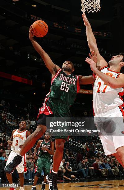 Maurice Williams of the Milwaukee Bucks goes for a layup against Zaza Pachulia of the Atlanta Hawks at Philips Arena on November 14, 2006 in Atlanta,...