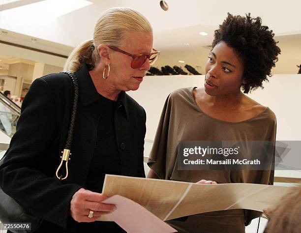 Michael Kors' mother Joan Kors and model Etirsa view the collection pamphlet at the Michael Kors in-store appearance and fashion show at Nieman...