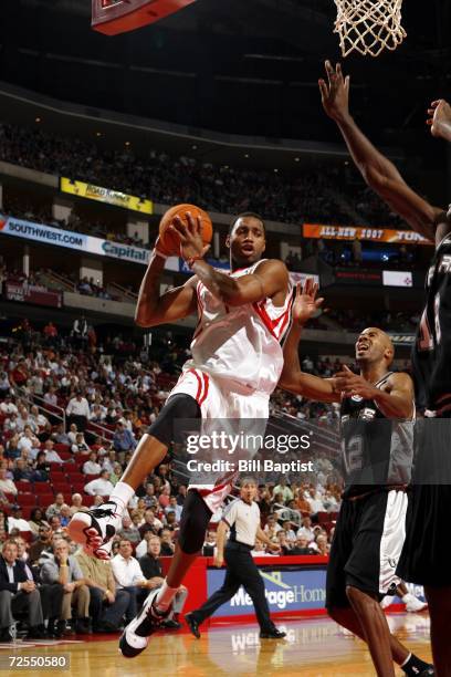 Tracy McGrady of the Houston Rockets shoots over Bruce Bowen and Francisco Elson of the San Antonio Spurs on November 14, 2006 at the Toyota Center...