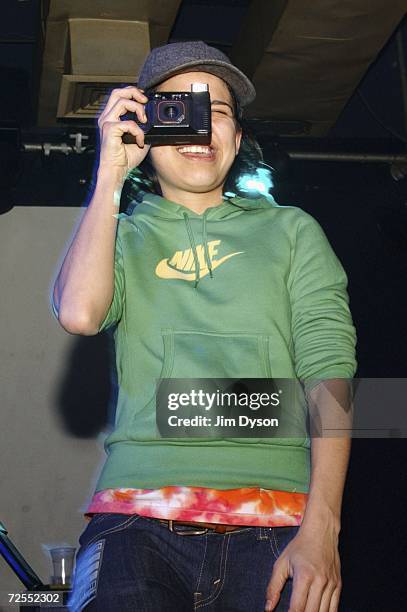 Guitar player, Ana Rezende, of Sao Paulo electro-pop sextet CSS takes a photo of the audience at the Scala in King's Cross on November 14, 2006 in...