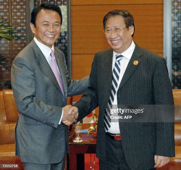 Japanese Foreign Minister Taro Aso is greeted by Vietnamese deputy Prime Minister and Foreign Minister Pham Gia Khiem prior to their bilateral...