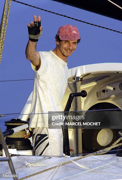 Pointe-a-Pitre, FRANCE : French sailor Marc Guillemot waves aboard his Imoca class monohull "Safran", 15 November 2006, as he arrives 7th at...