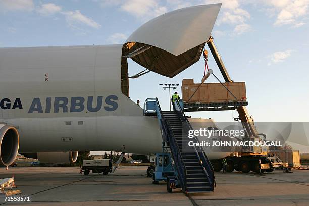 Container holding a 5-meter high granite statue of a Ptolemaic Pharao is lifted into an Airbus Beluga transport aircraft at Schoenefeld airport 15...