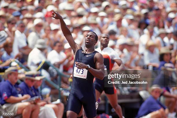 Michael Johnson of the USA celebrates after placing first in the Men's 400 meter Dash Event of the 2000 U.S. Olympic Track & Field Team Trials at the...