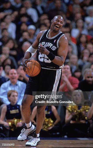 Jerome Kersey of the San Antonio Spurs laughs and moves with the ball during the game against the Denver Nuggets at the Alamodome in San Antonio,...