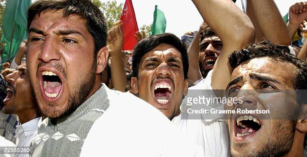 Shi'ite Muslims protest near the local headquarters of the U.S.-led Coalition Provisional Authority July 20, 2003 in Najaf, Iraq. Over 10,000 angry...