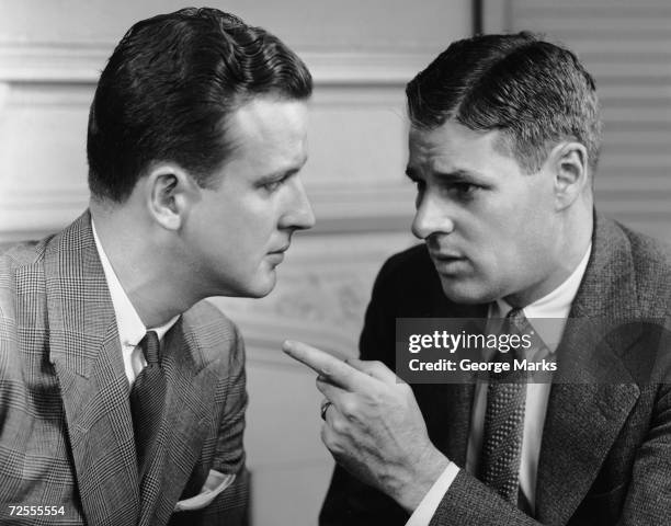 1950s: Two men arguing.