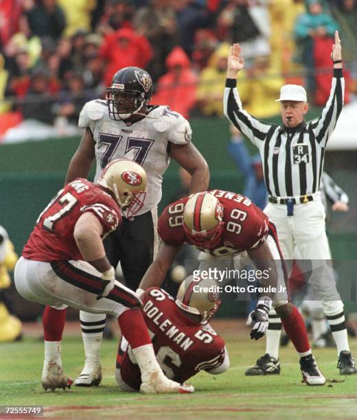 'Linebacker Chris Doleman of the San Francisco 49ers is congratulated by teammates Daved Benefield and and Bryant Young after recovering a Baltimore...