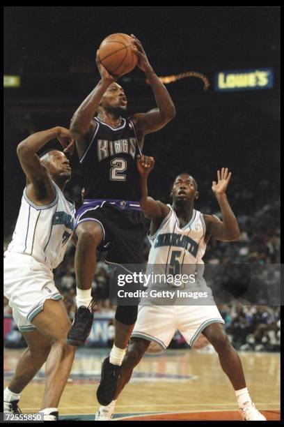 Guard Mitch Richmond of the Sacramento Kings works against guard Anthony Goldwire of the Charlotte Hornets during a game played at the Charlotte...