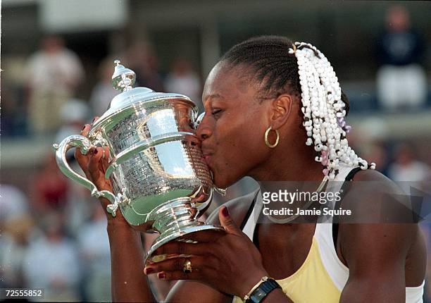 American tennis player Serena Williams kisses her trophy after winning a match during the US Open at the USTA National Tennis Courts in Flushing...