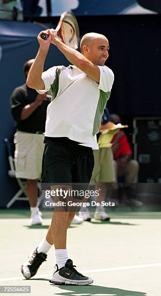 Tennis star Andre Agassi plays a match August 26, 2000 at the Arthur Ashe Kids'' Day Family and Music Festival at the USTA National Tennis Center in...