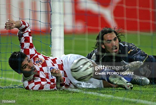 Croatian player Eduardo da Silva scores the third goal as Israeli goalkeeper Dudu Awat falls on the ground behind him during their EURO 2008 football...