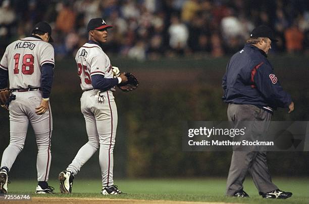 Outfielder Andruw Jones of the Atlanta Braves has words with umpire Bruce Froemming during the National League Division Playoff Series Game 3 against...