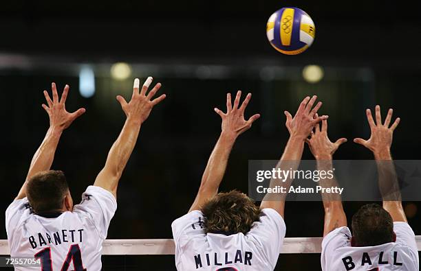 Kevin Barnett, Ryan Millar and Lloy Ball of the United States jump to block the ball against Russia during the men's indoor Volleyball bronze medal...