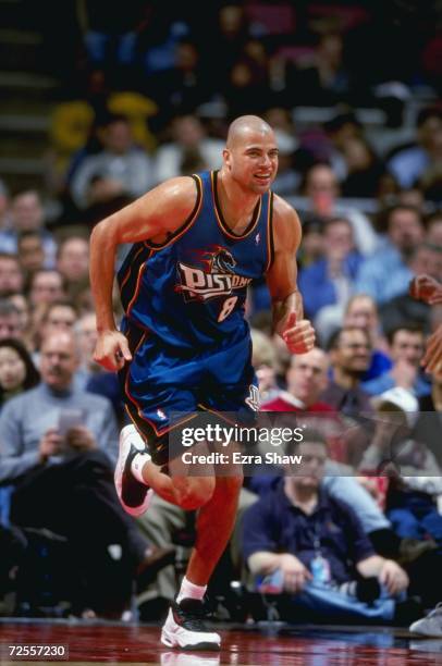 Bison Dele of the Detroit Pistons smiles as he runs down the court during a game against the New Jersey Nets at the Continental Airlines Arena in...