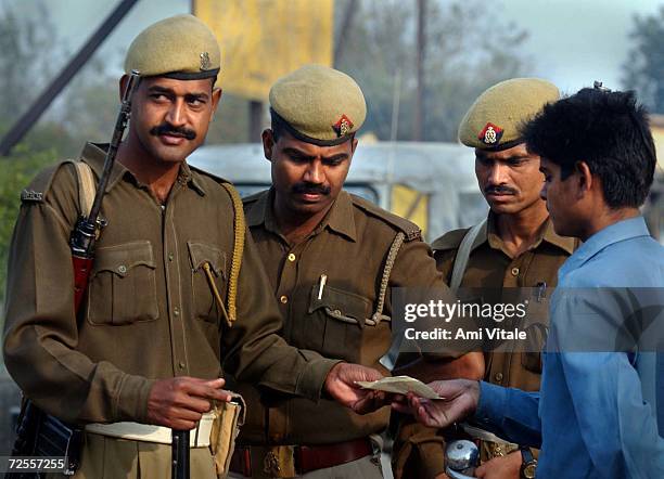 Indian police check identification of people in the northern Indian city of Ayodhya, March 9, 2002 in anticipation of the thousands of Hindu pilgrims...
