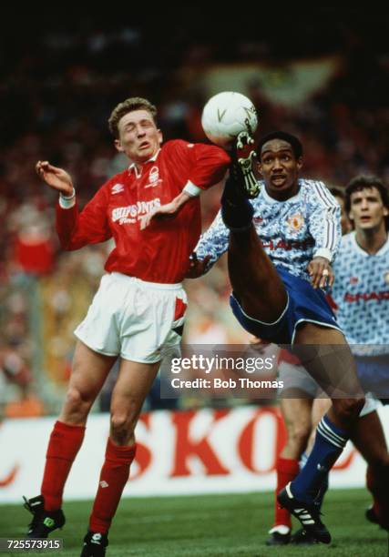 Paul Ince of Manchester United is challenged by Scot Gemmill of Nottingham Forest during play in the Rumbelows League Cup Final at Wembley Stadium in...