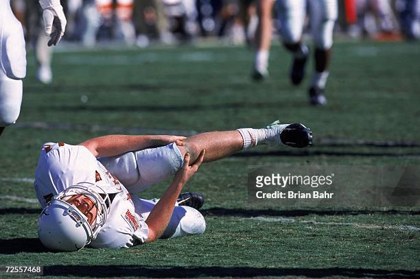 Major Applewhite of the Texas Longhorns injures his knee during the Cotton Bowl Game against the Arkansas Razorbacks at the Cotton Bowl in Dallas,...