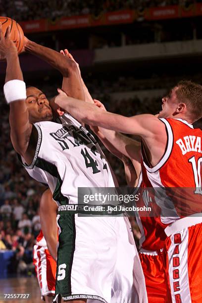 Morris Peterson of Michigan State fends off Jon Bryant of Wisconsin during the semifinal round of the NCAA Final Four at the RCA Dome in...