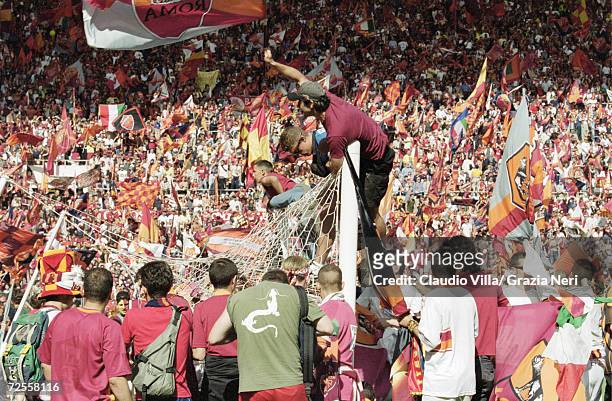 Roma fans celebrate the Scudetto by invading the pitch after a 3-1 victory in the Serie A match against Parma at the Stadio Olimpico in Rome....