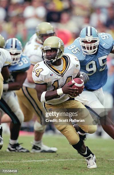 Joe Hamilton of the Georgia Tech Yellow Jackets moves with the ball during the game against the North Carolina Tar Heels at the Bobby Dodd Stadium in...