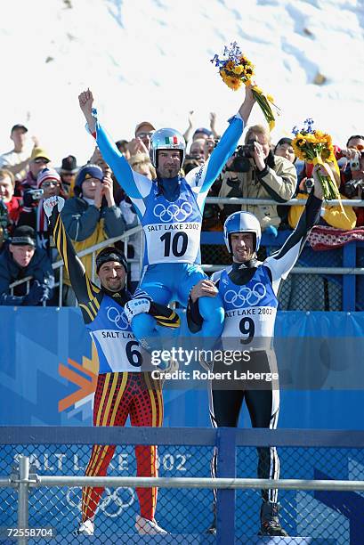 Armin Zoeggeler of Italy claims gold in the men's luge singles event beating silver winner Georg Hackl of Germany and bronze medallist Markus Prock...