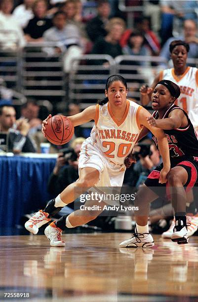 Kara Lawson of the Tennessee Volunteers runs with the ball as Tasha Pointer of the Rutgers Scarlet Knights gaurds her during the NCAA Women''s Finals...