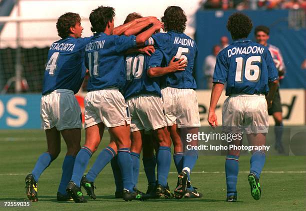 ROBERTO BAGGIO CELEBRATES WITH HIS TEAM MATES AFTER SCORING THE FIRST OF HIS GOALS AGAINST BULGARIA DURING THEIR 1994 WORLD CUP SEMI-FINAL MATCH AT...