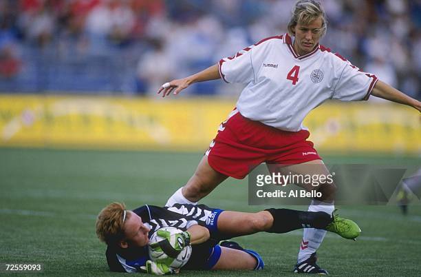 Joanne Axelsen of Team Denmark kicks at goalie Bente Nordby of Team Norway during a womens soccer match of the Goodwill Games at the Mitchel Athletic...