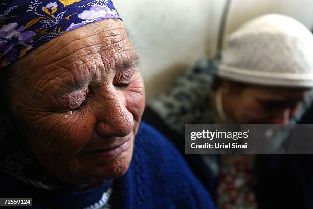 Relatives weep at the funeral for Herzl Shlomo, a victim of the Karni crossing suicide attack, on January 14, 2005 in Sderot, Israel. All border...