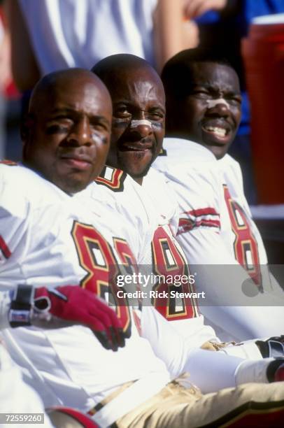 Wide Receiver Jerry Rice of the San Francisco 49ers and teammates J.J. Stokes and Terrell Owens look on during a game against the Buffalo Bills at...