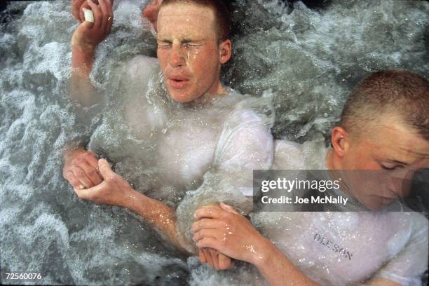 Navy Seal trainees cringe as they lie in the frigid Pacific surf in this undated photo taken in 2000 at the Coronado Naval Amphibious Base in San...