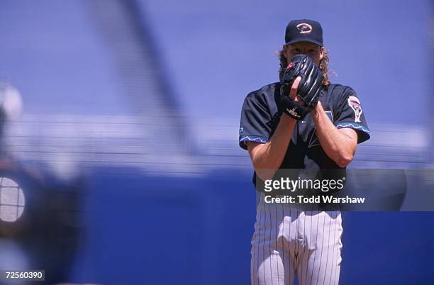 Pitcher Randy Johnson of the Arizona Diamondbacks gets ready to pitch the ball during the game against the San Diego Padres at Qualcomm Stadium in...