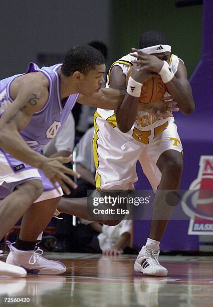 Ron Slay of Tennessee calls a timeout as he struggles with a loose ball with Jason Capel of North Carolina during the NCAA South Regional at the...