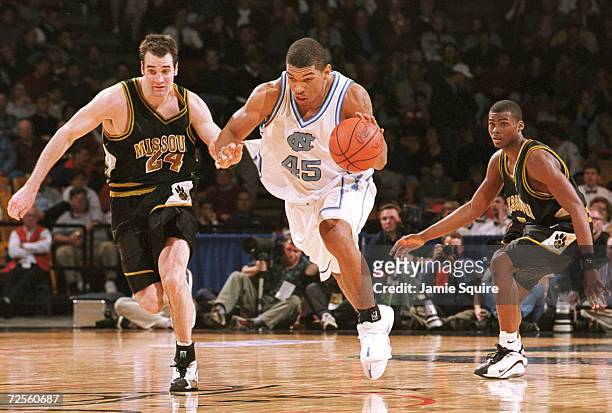 Julius Peppers of UNC drives down the court on Jeff Hafer of Missouri during the second half of North Carolina''s 84-70 victory at the NCAA...