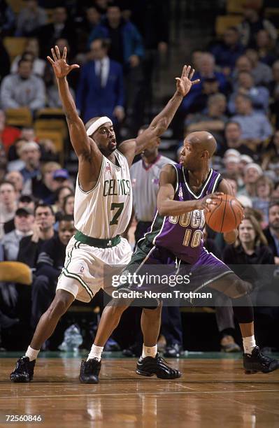 Point guard Sam Cassell of the Milwaukee Bucks attempts to pass as point guard Kenny Anderson of the Boston Celtics palys defense during the NBA game...