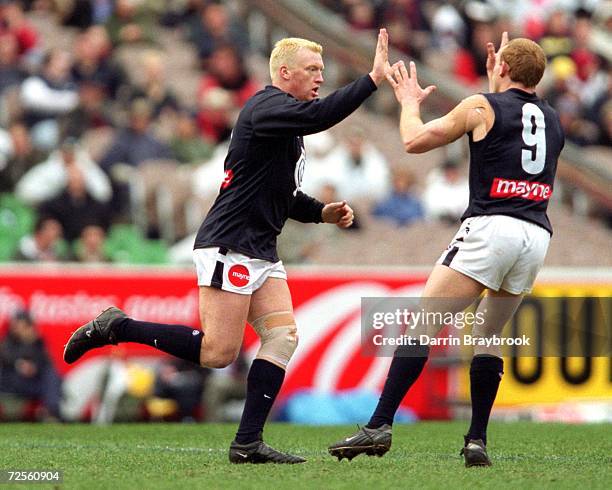 Lance Whitnall and Adrian Hickmott for Carlton celebrate a goal during the round 18 AFL match played between the Essendon Bombers and the Carlton...